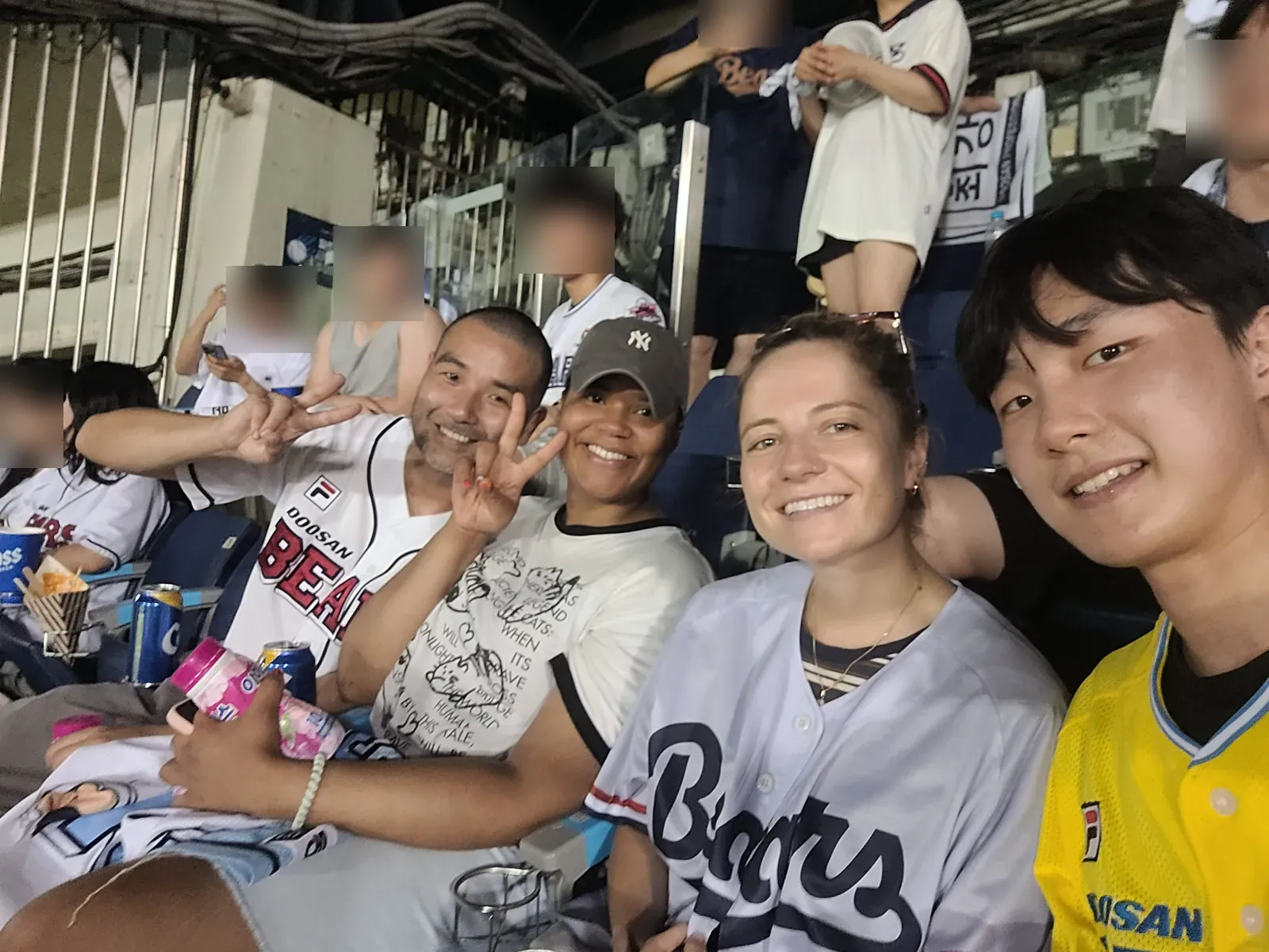 HanBuddy guests and local buddies taking a selfie together in the stands at Jamsil Baseball Stadium