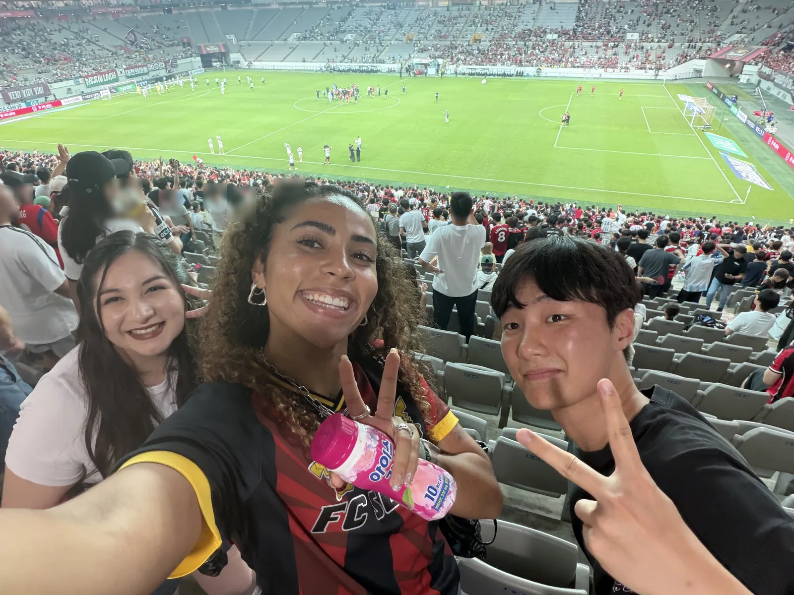 HanBuddy guests and their local buddy taking a selfie in the stands at Seoul World Cup Stadium